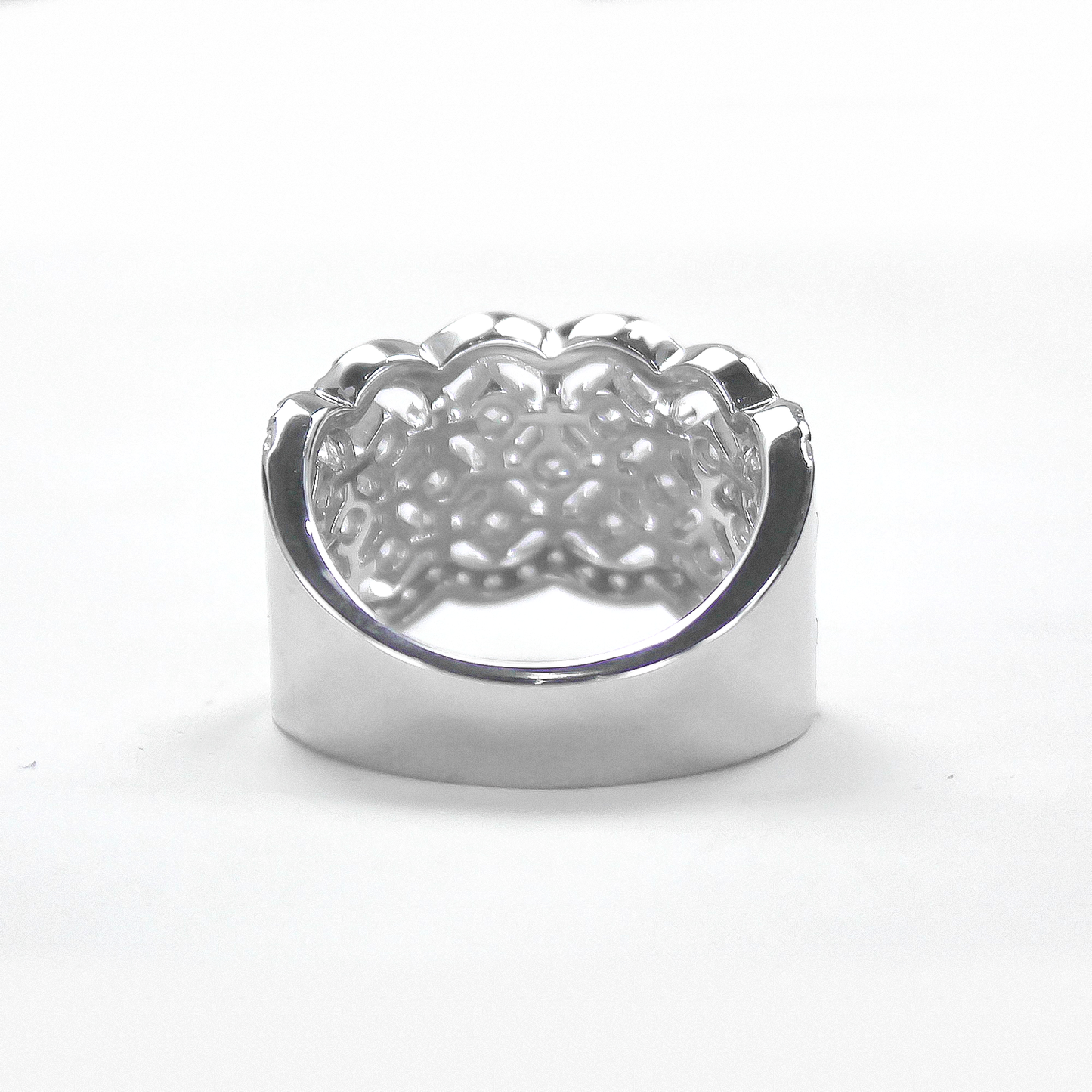 Back view of Lattice pavé moissanite band ring lying flat on white background
