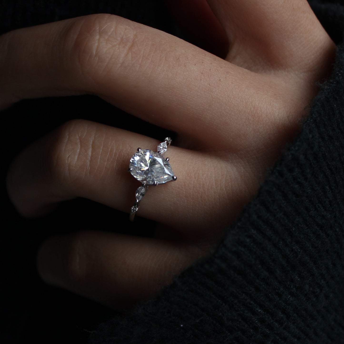 Elara pear moissanite ring in white gold plated sterling silver on white background