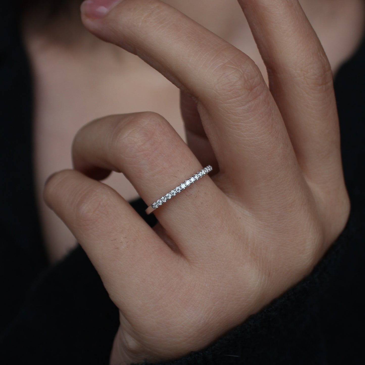 Micro pavé moissanite band close-up on hand, silver tone 2