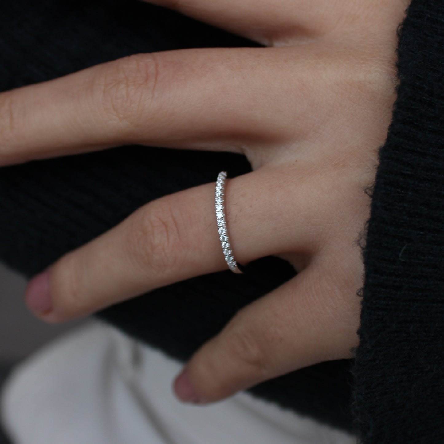 Micro pavé moissanite band close-up on hand, silver tone