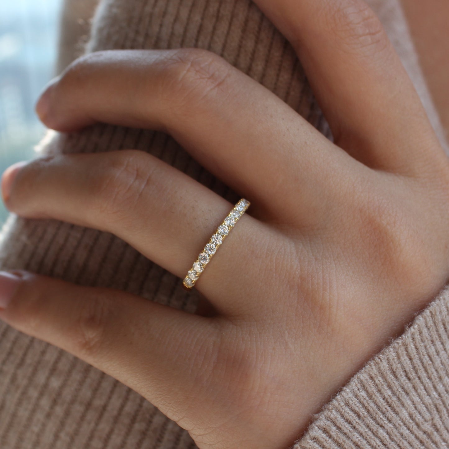 Aeris micro pavé moissanite band worn on hand, gold tone