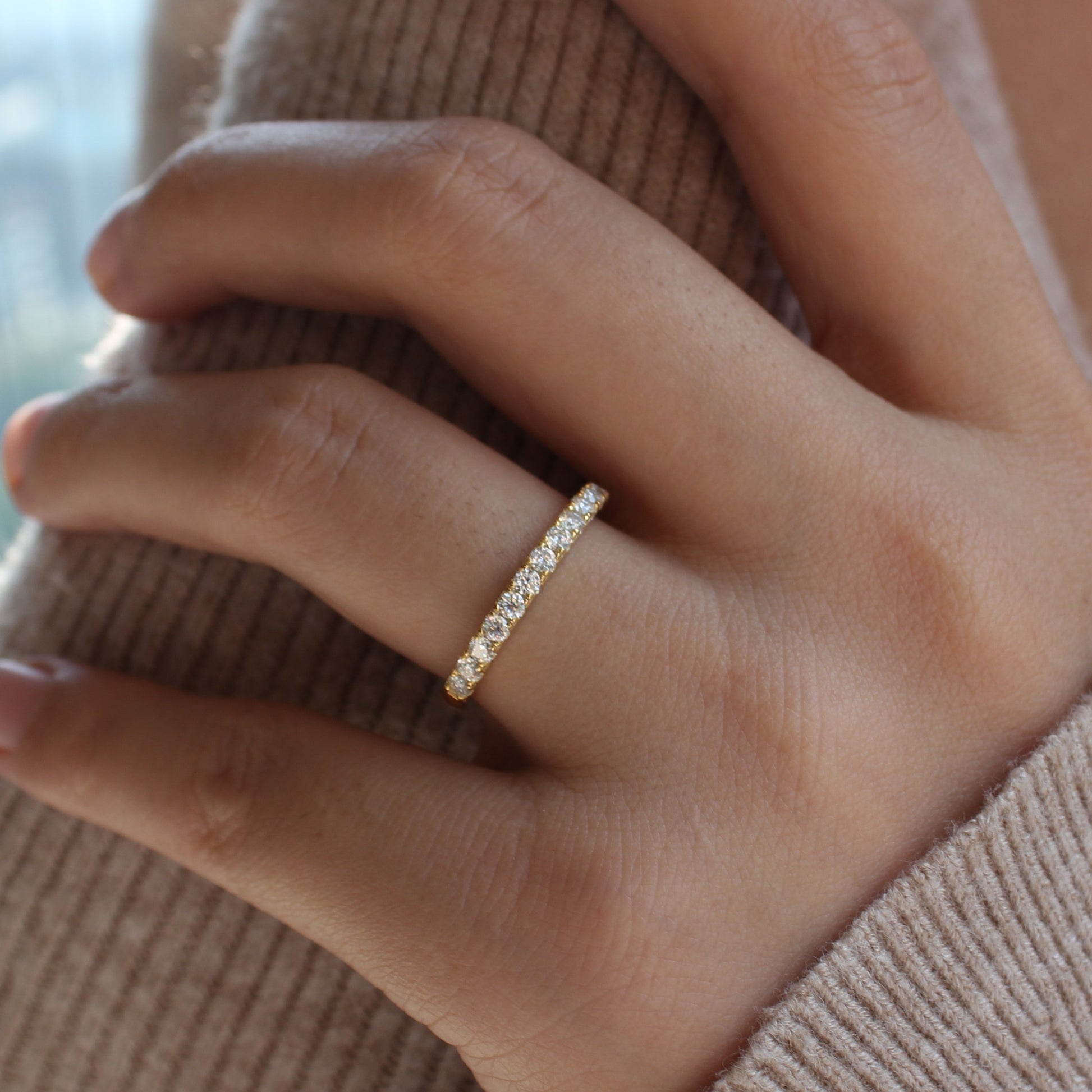 Aeris micro pavé moissanite band worn on hand, gold tone