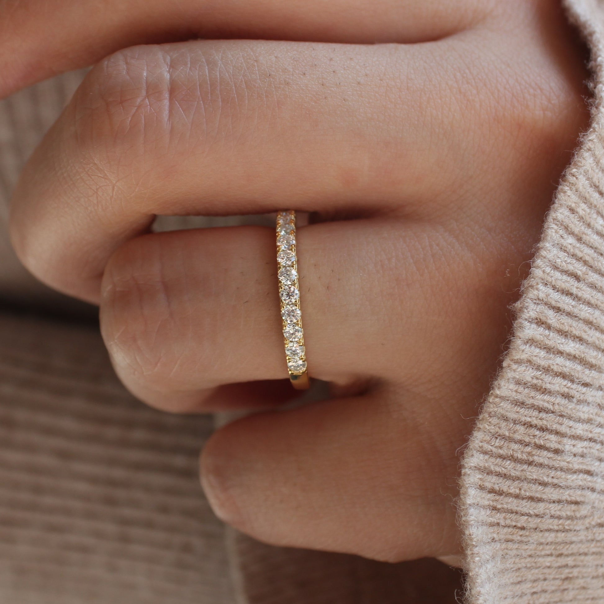 Aeris micro pavé moissanite band worn on hand, white gold tone