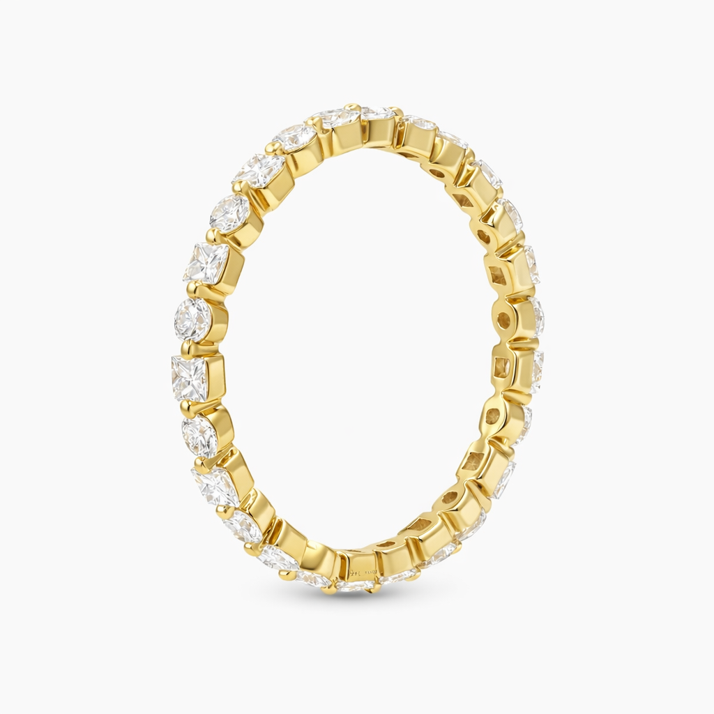 Flat lay of alternating moissanite eternity band on white background