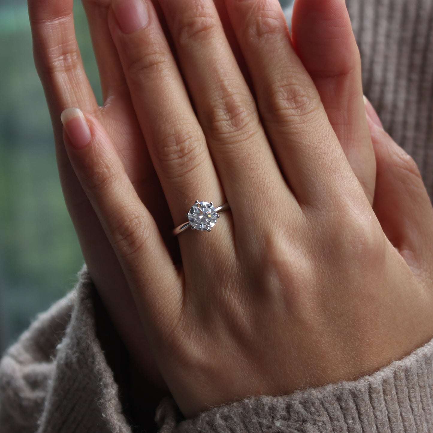 aurelia moissanite ring close up on hand sparkle detail
