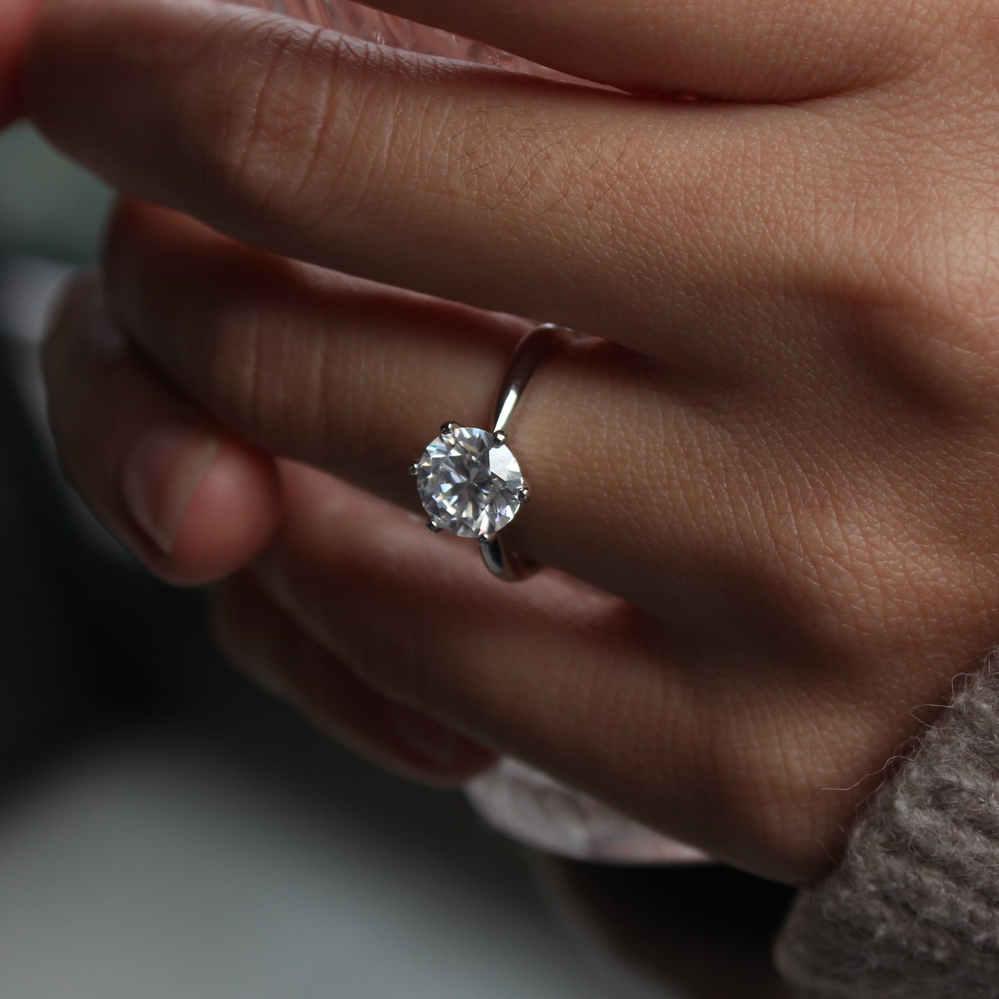 aurelia moissanite ring white gold tone on hand
