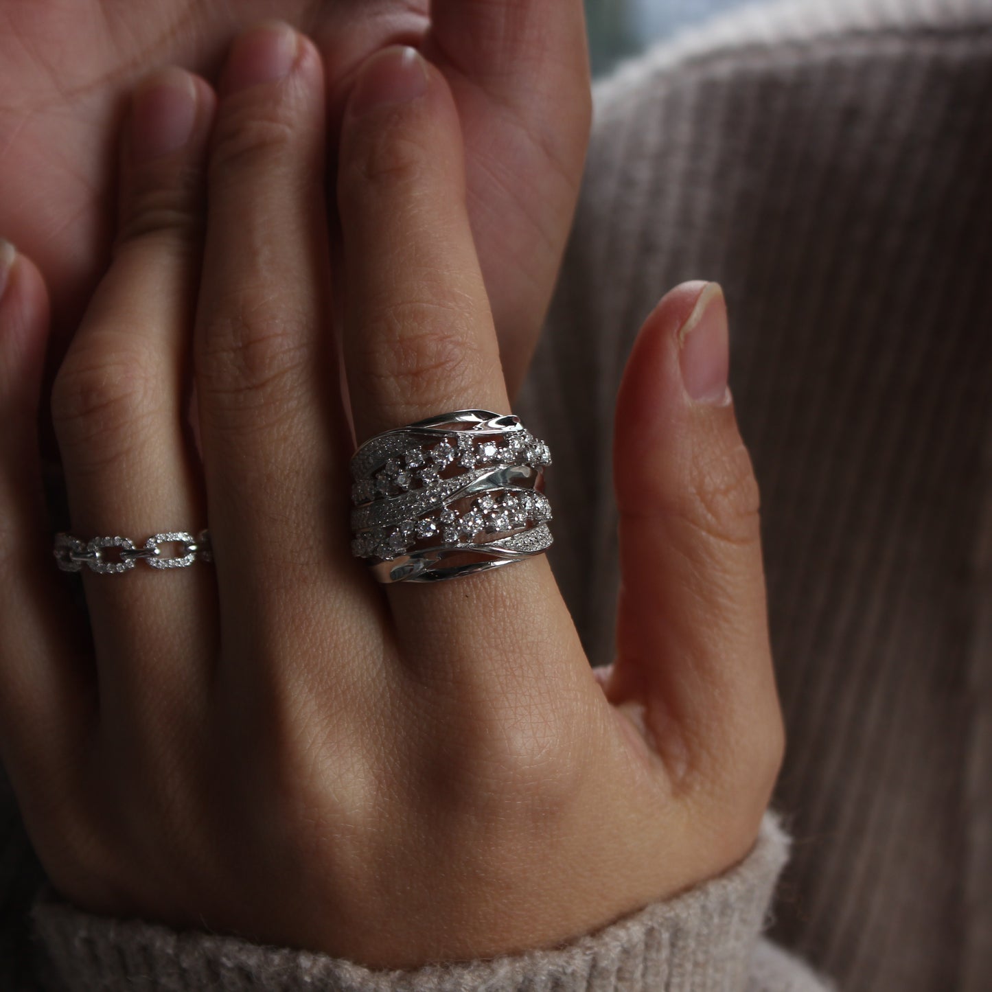 Elegant white gold tone moissanite band ring worn in natural daylight