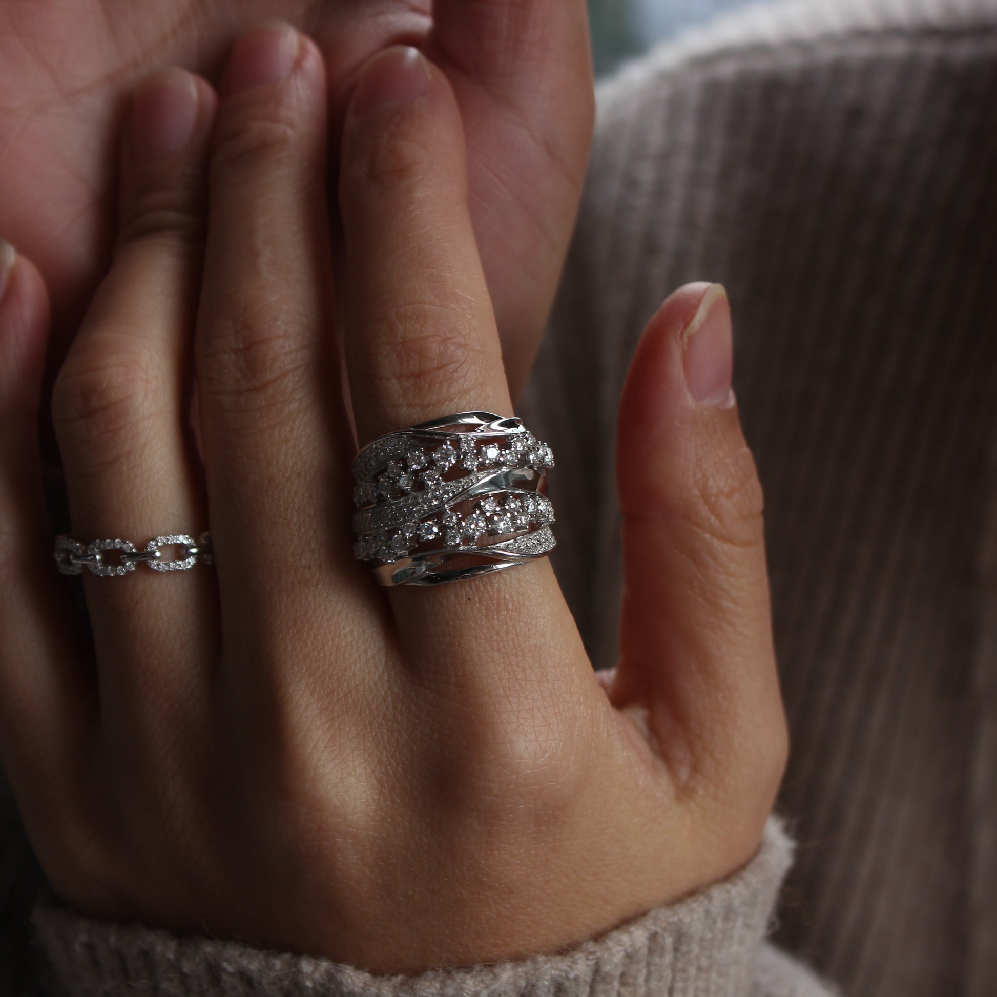 Elegant white gold tone moissanite band ring worn in natural daylight