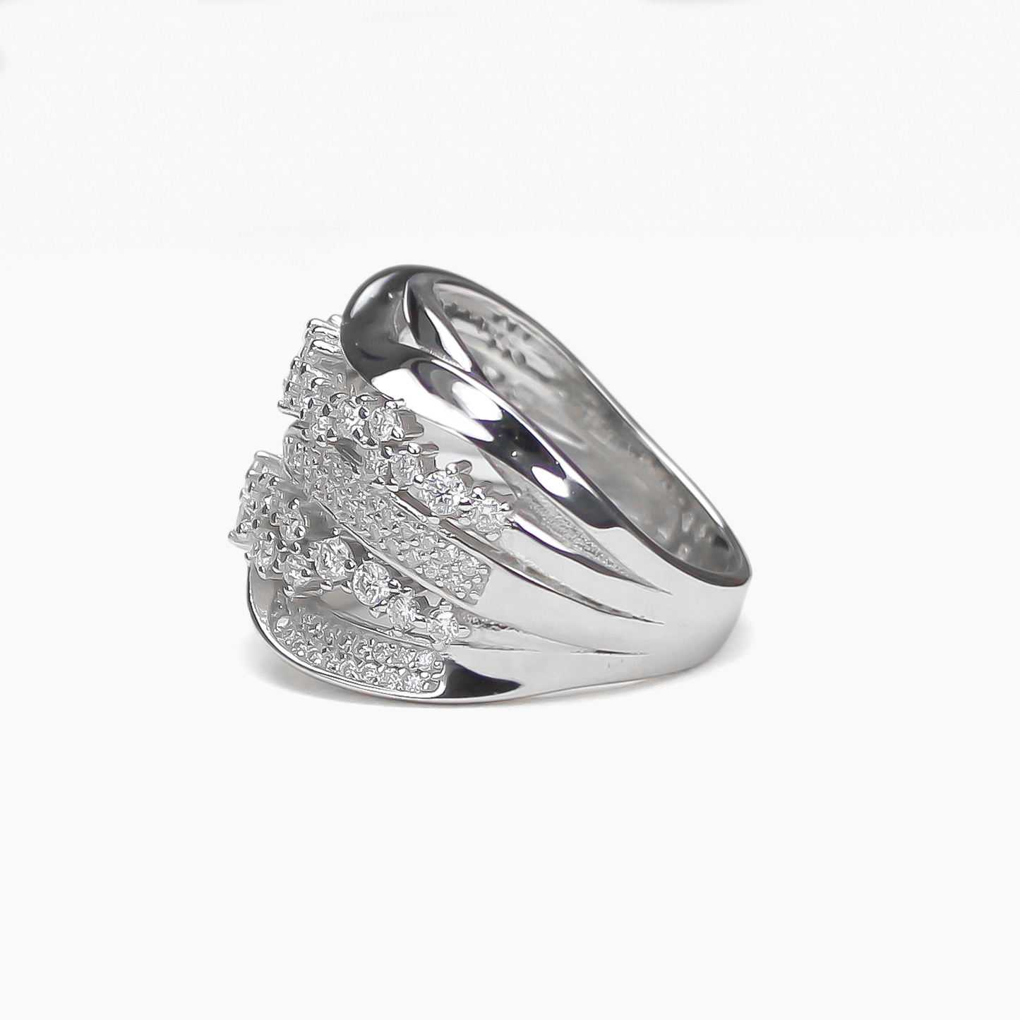 Side profile of Aurora pavé moissanite band ring lying flat on white background