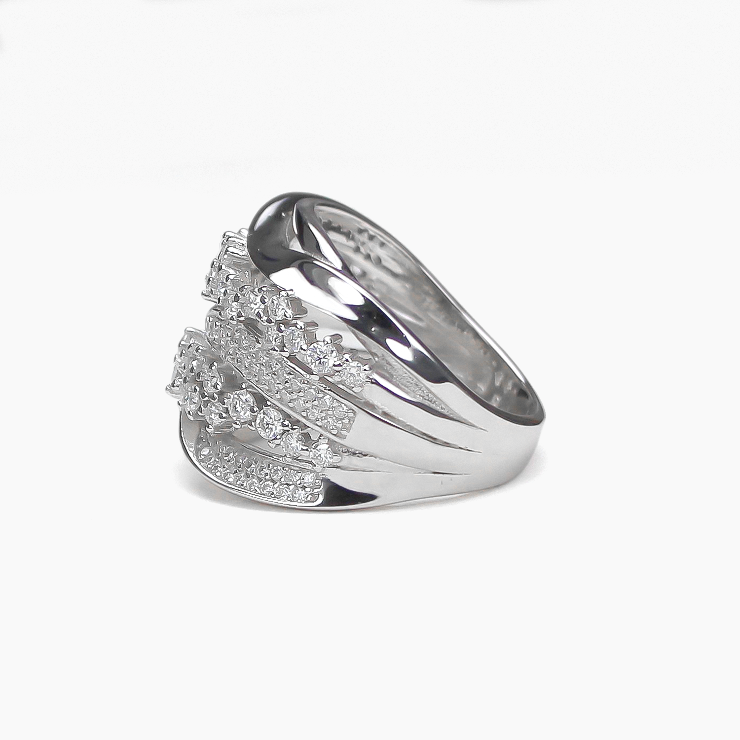 Side profile of Aurora pavé moissanite band ring lying flat on white background