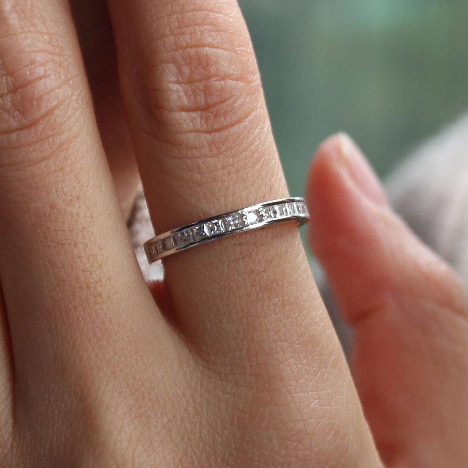 Baguette moissanite band ring styled on hand, white gold tone stacking look