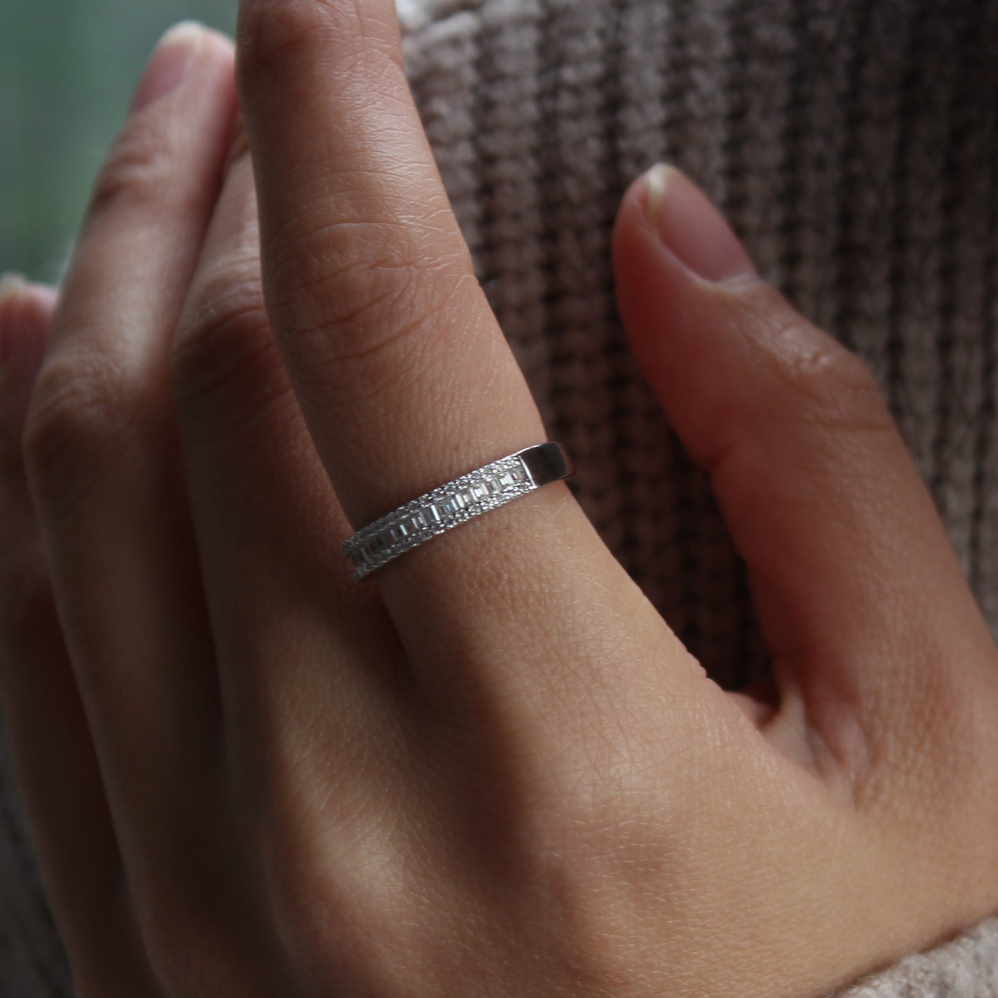 Pavé baguette moissanite band ring on hand, white gold tone with refined sparkle