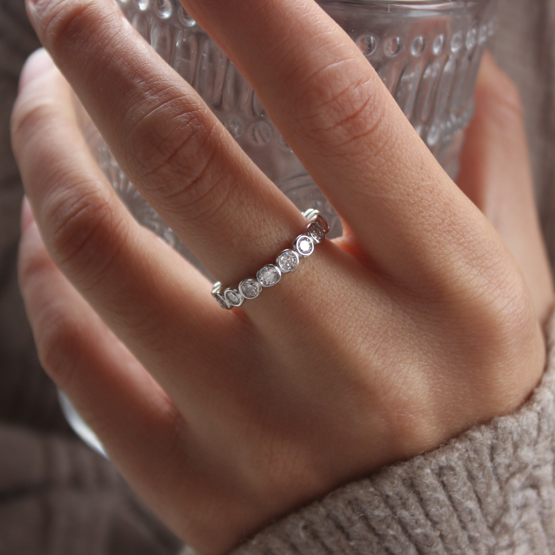 Bezel eternity moissanite ring styled for daily wear, white gold tone