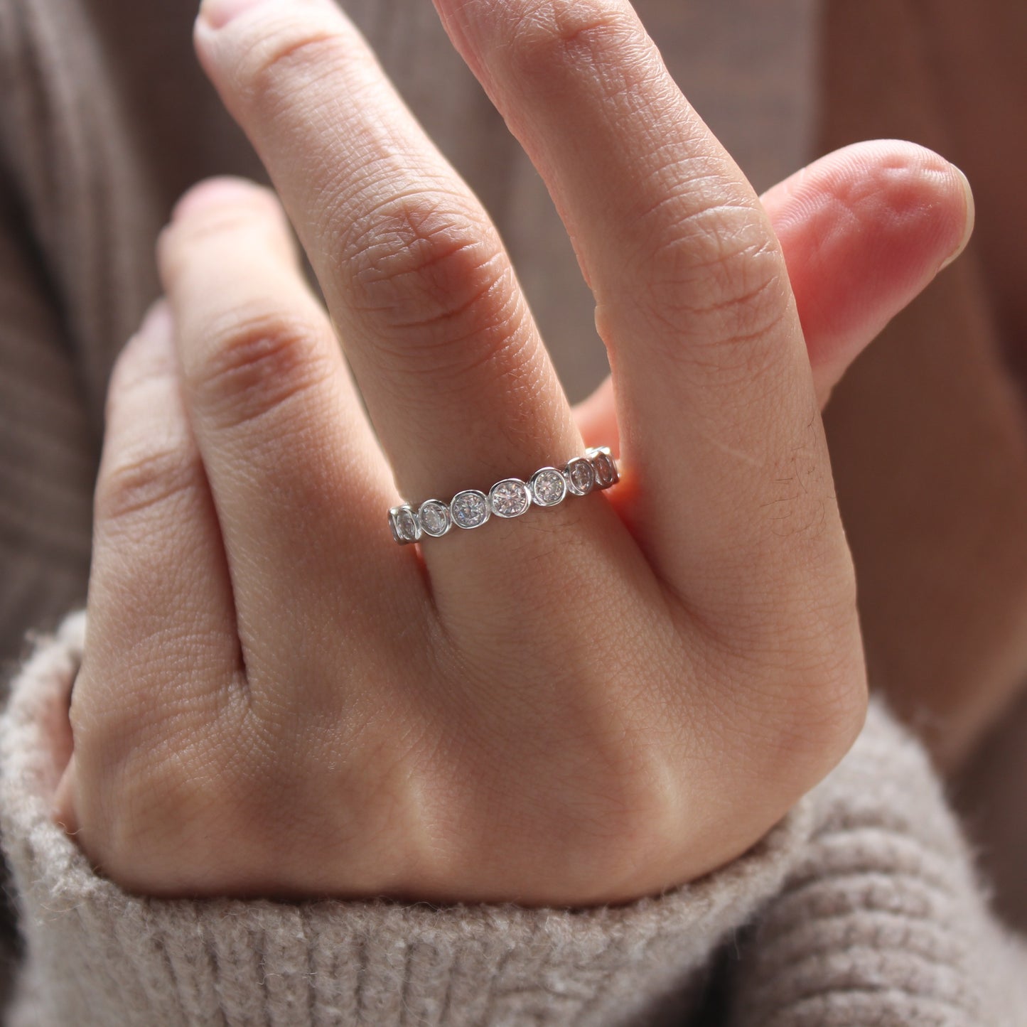 Stacking look with bezel eternity moissanite ring in white gold tone