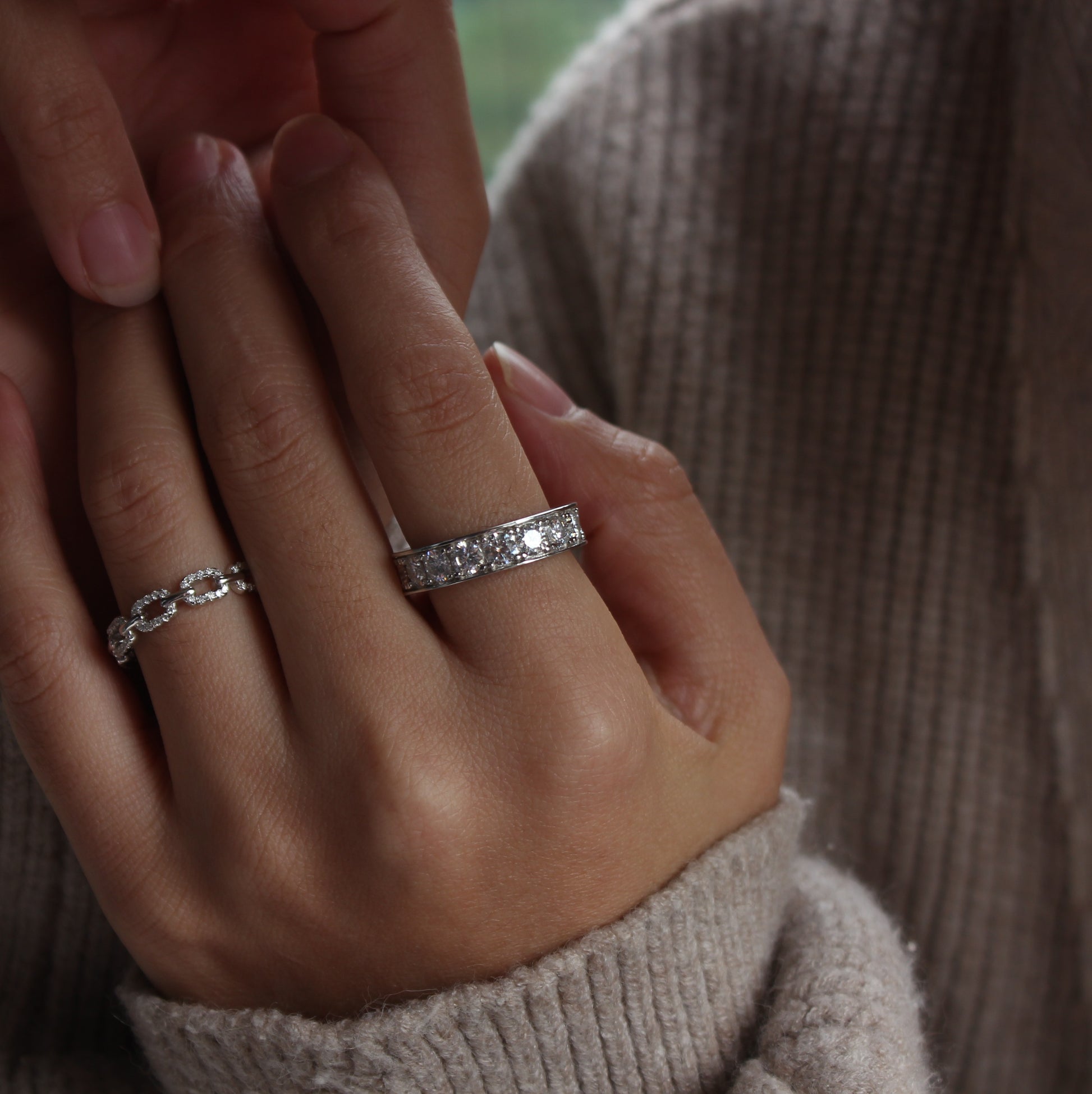 Celeste eternity moissanite band ring in white gold tone worn on hand, minimalist everyday style