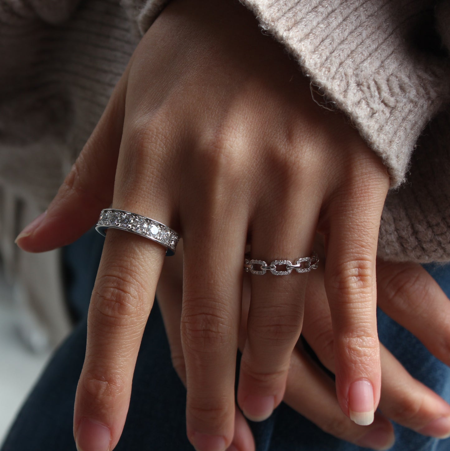 Eternity moissanite band ring on hand, white gold tone with subtle sparkle