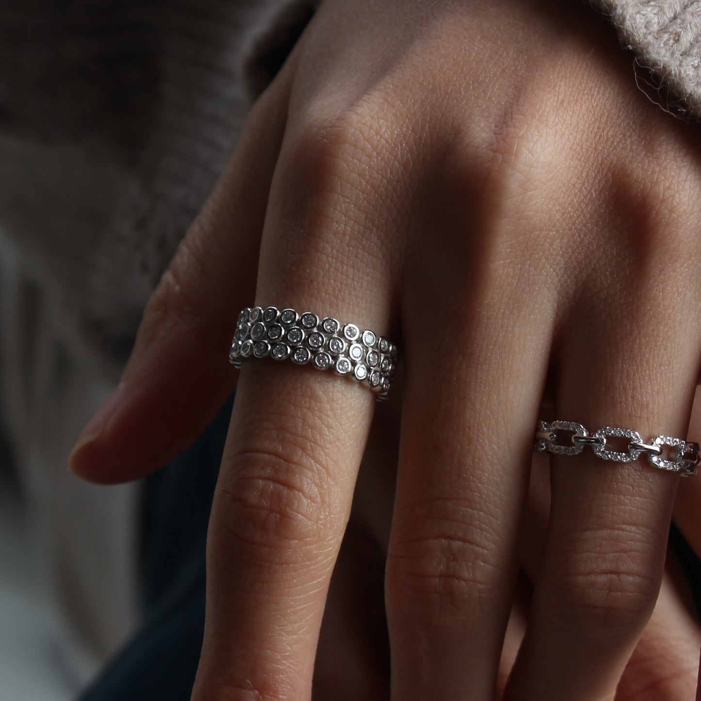 Elegant white gold tone dome pavé ring worn in natural daylight