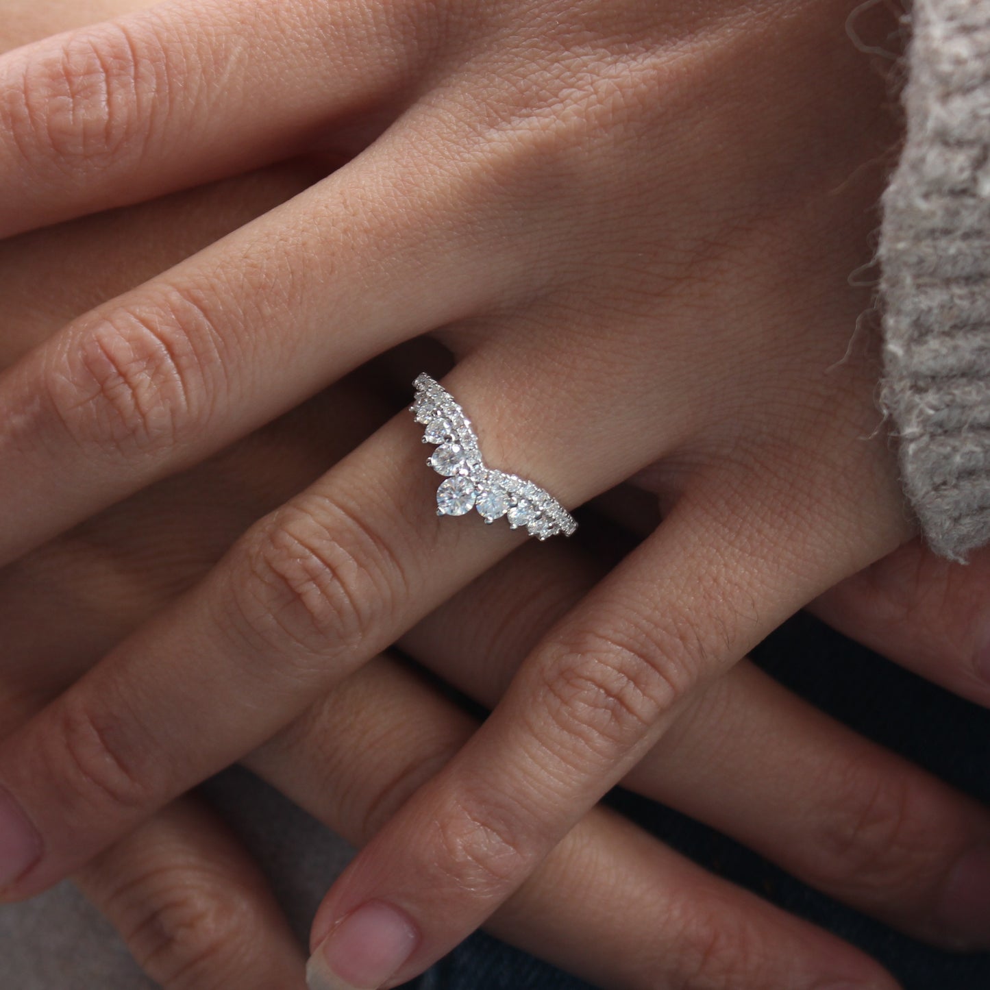 Close view of double row moissanite pavé band on finger