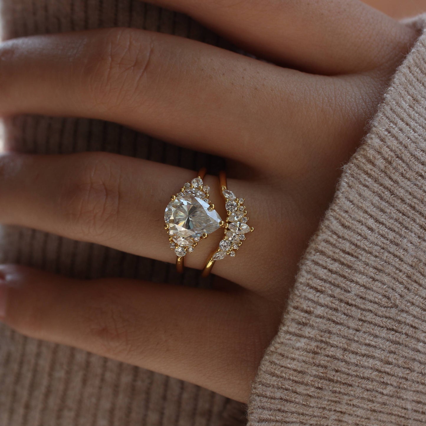 Lifestyle image of duo pear-cut moissanite ring set worn on fingers
