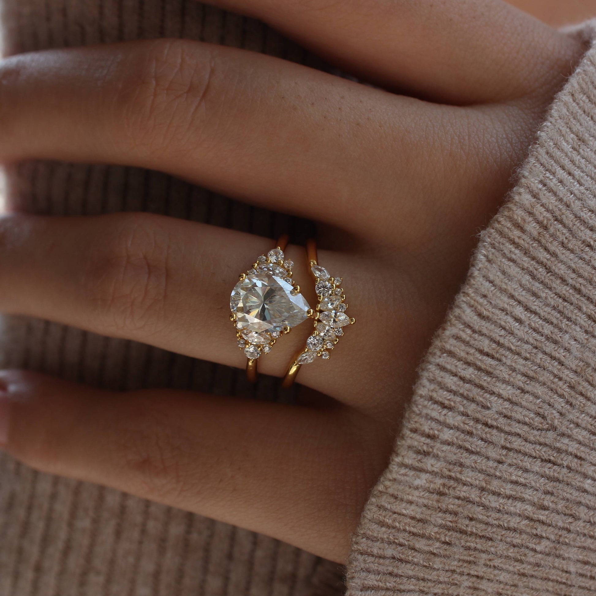 Lifestyle image of duo pear-cut moissanite ring set worn on fingers