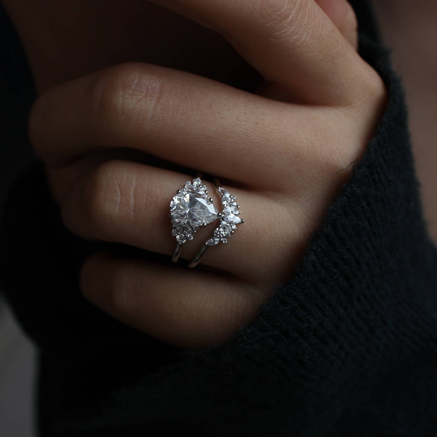Minimal hand styling showcasing pear-cut moissanite ring set