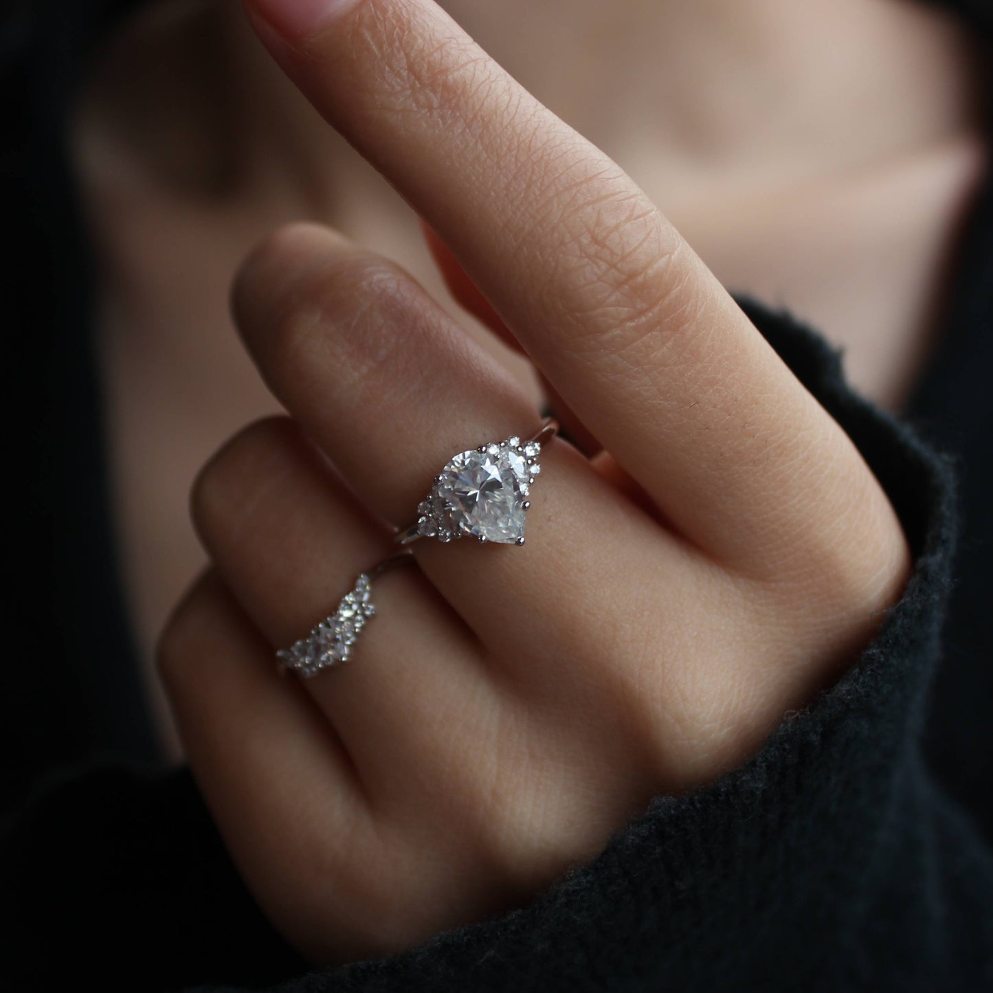 Stacked styling of duo pear-cut moissanite rings on hand