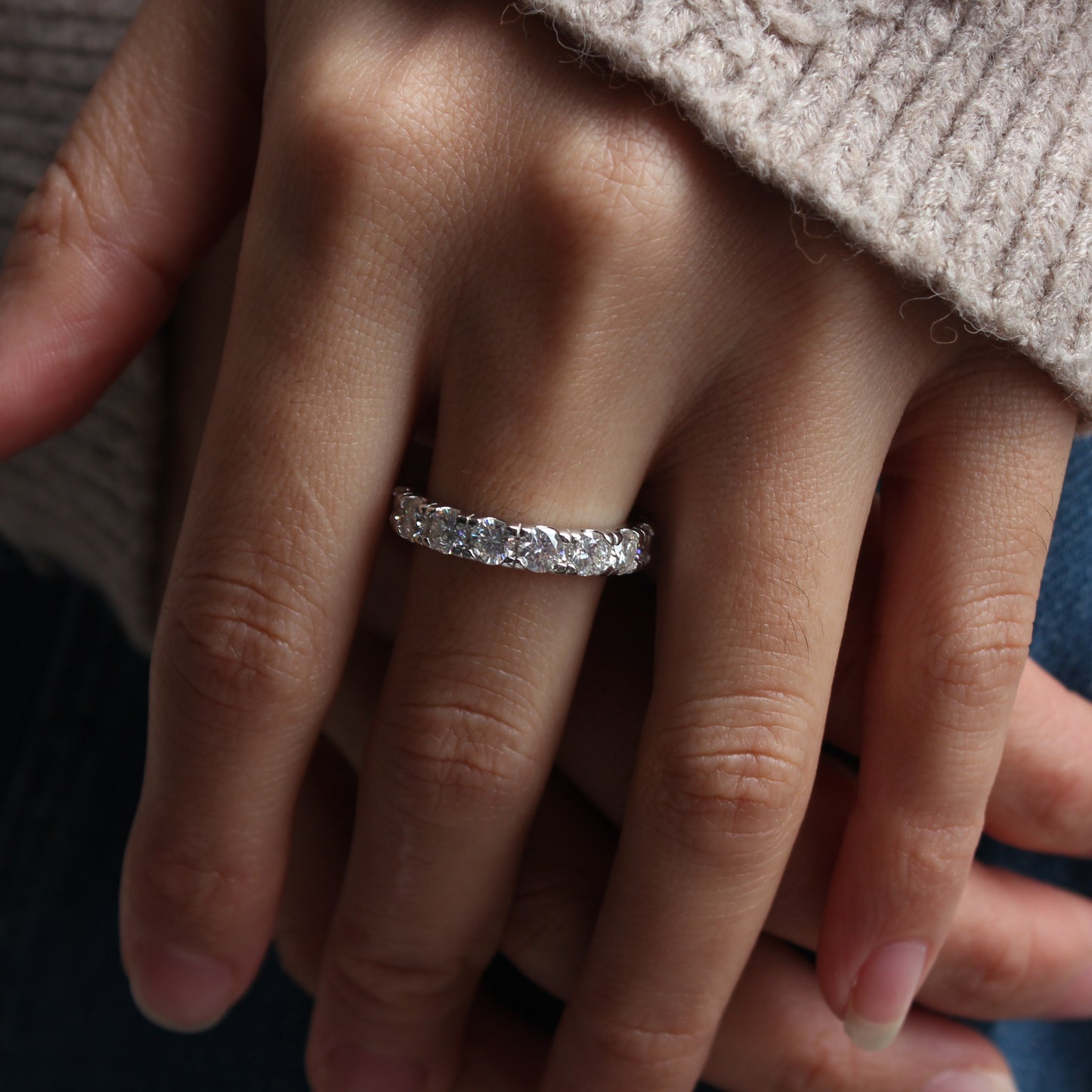 Close-up of Elara eternity moissanite band ring worn on finger, refined everyday look