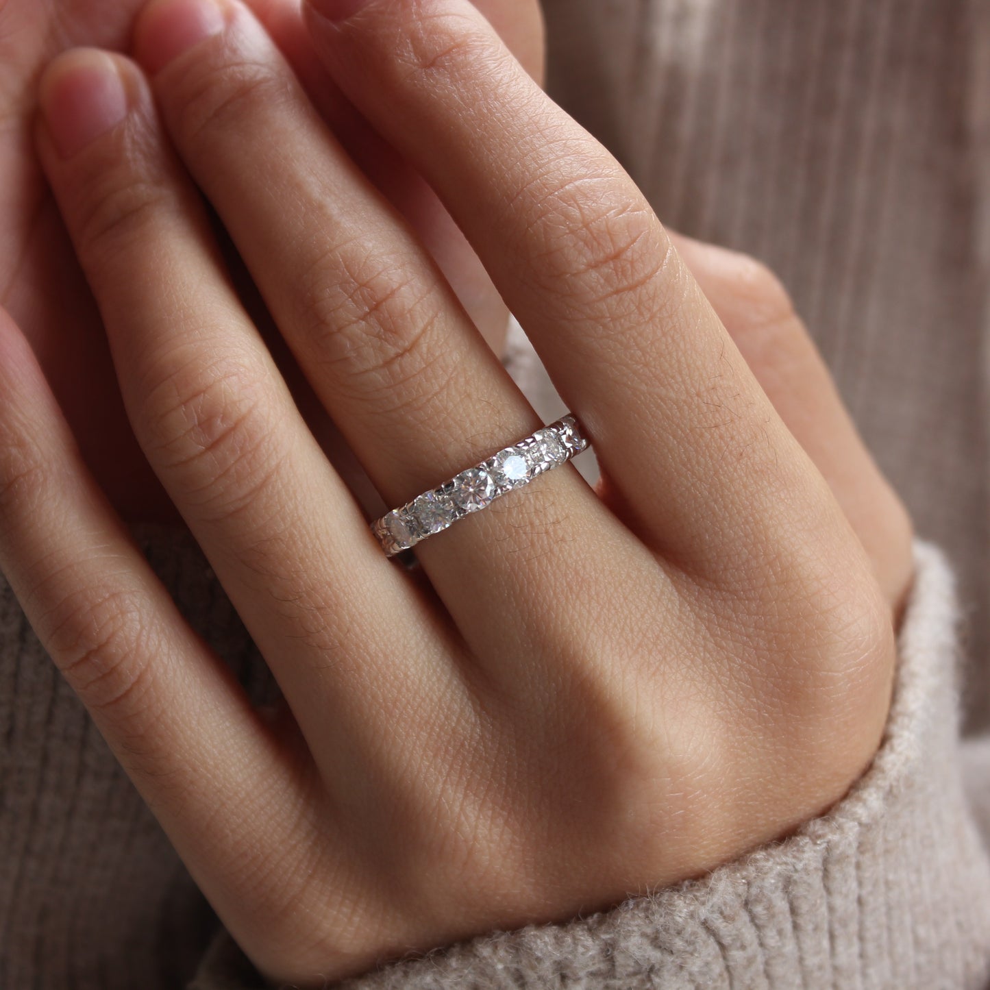 Minimalist styling of Elara moissanite eternity band ring on hand