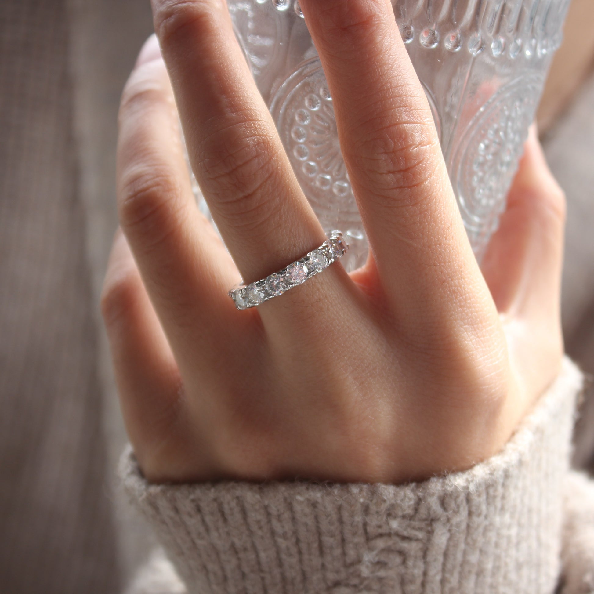 Lifestyle hand photo featuring Elara moissanite eternity band ring