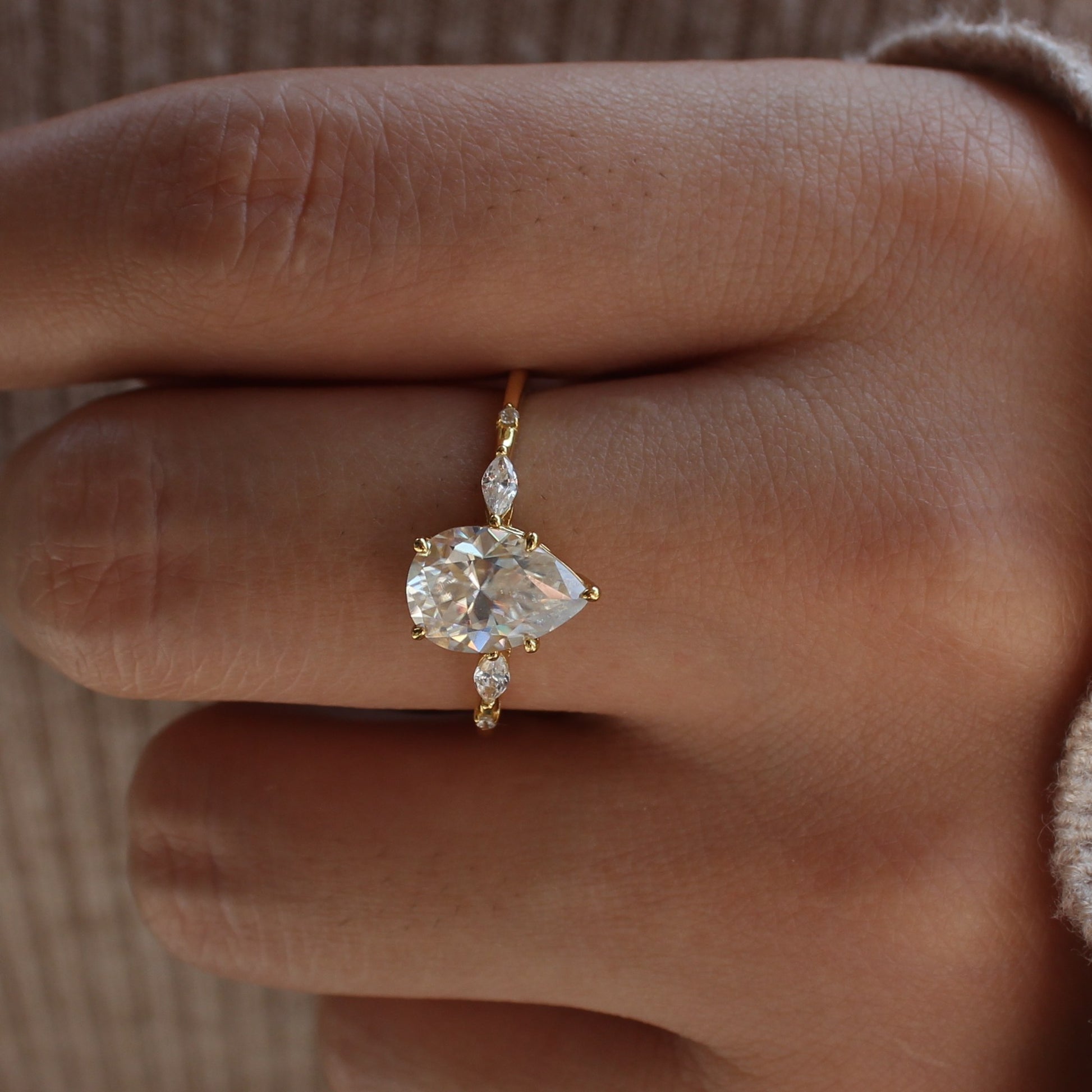 Elara pear moissanite ring displayed on hand