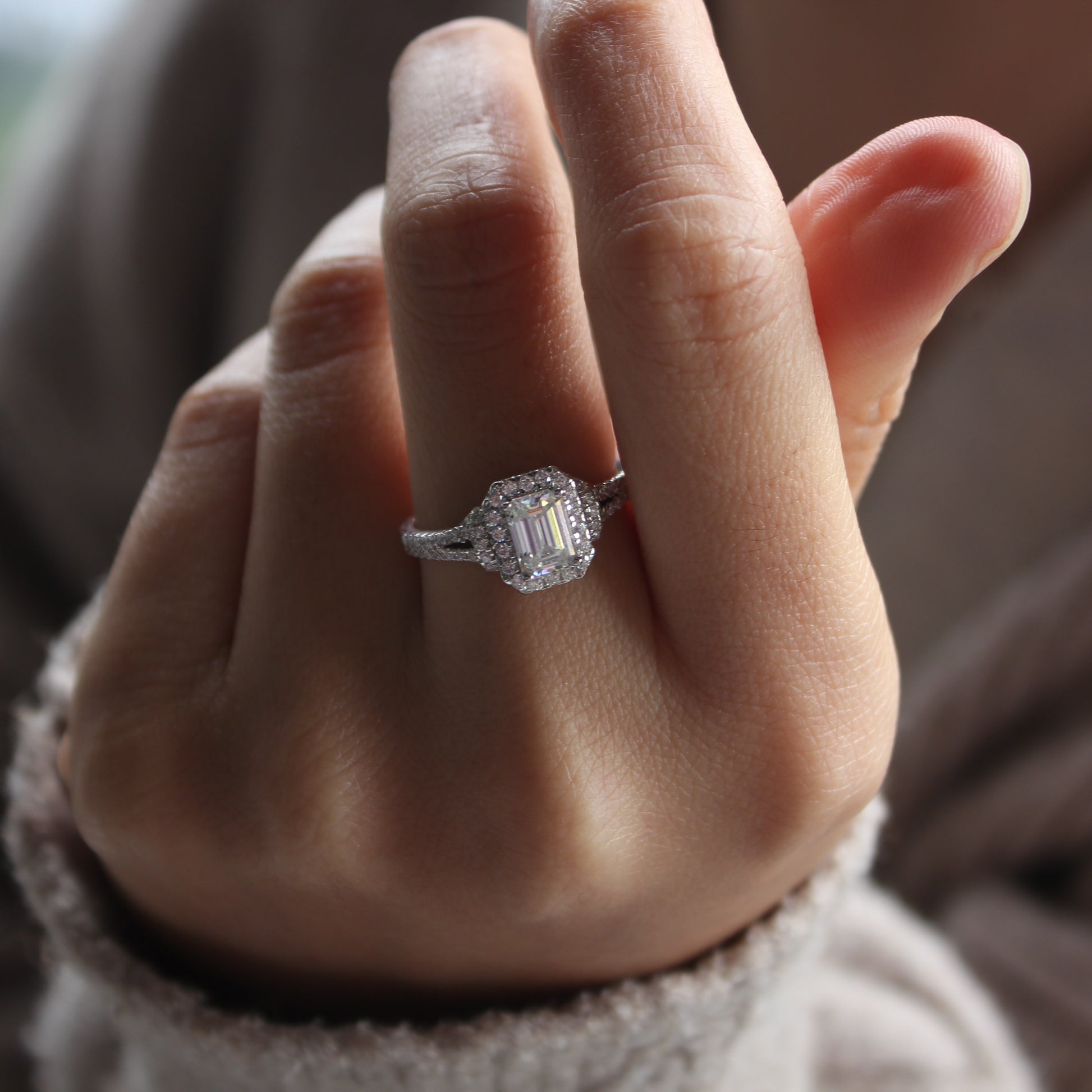 Minimal halo moissanite ring worn on hand, white gold tone aesthetic