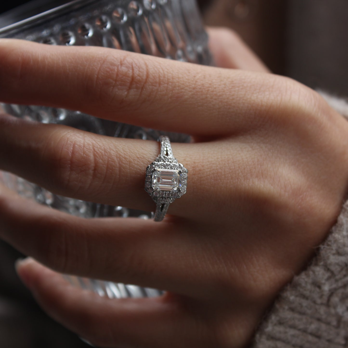 Emerald cut moissanite ring styled on hand, white gold tone for everyday wear