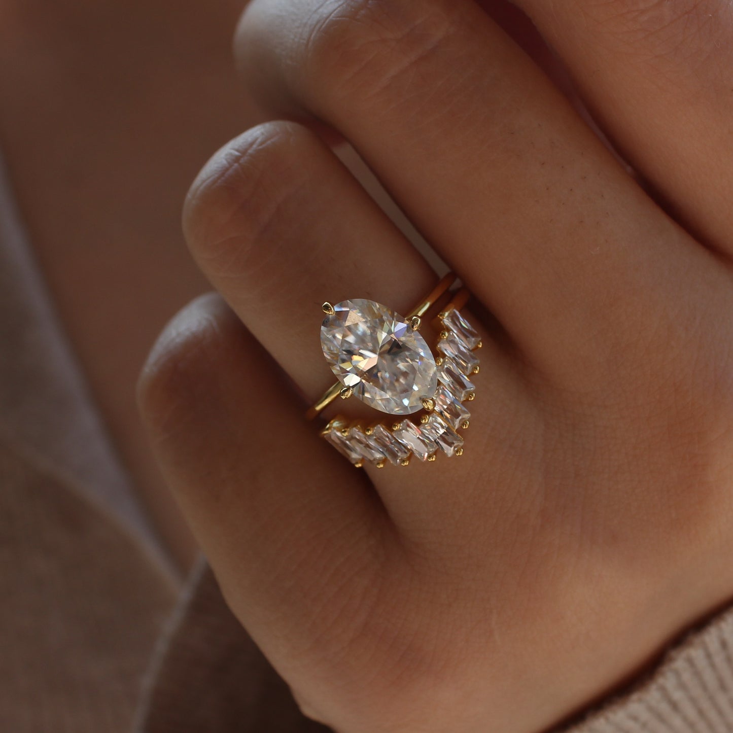 Geometric cluster moissanite ring worn on hand, gold tone