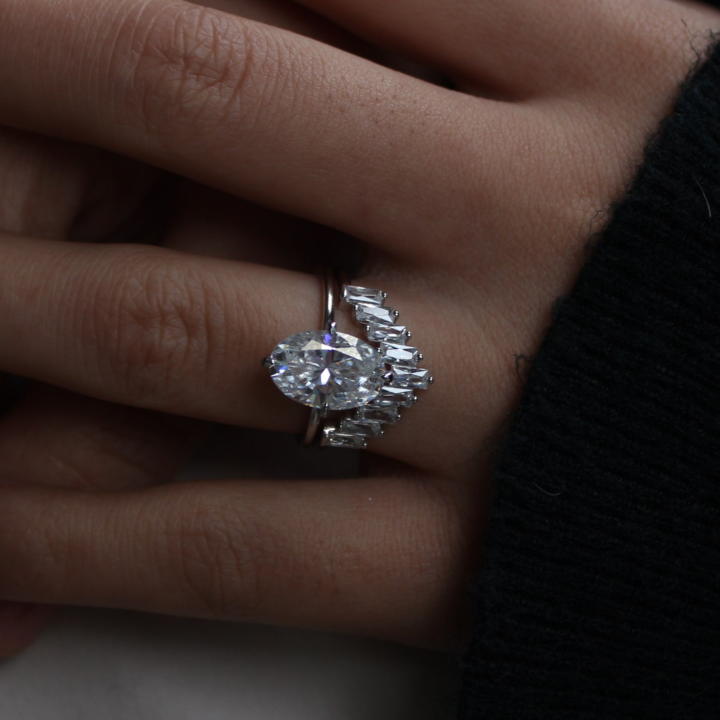 Moissanite cluster ring worn on finger, front view