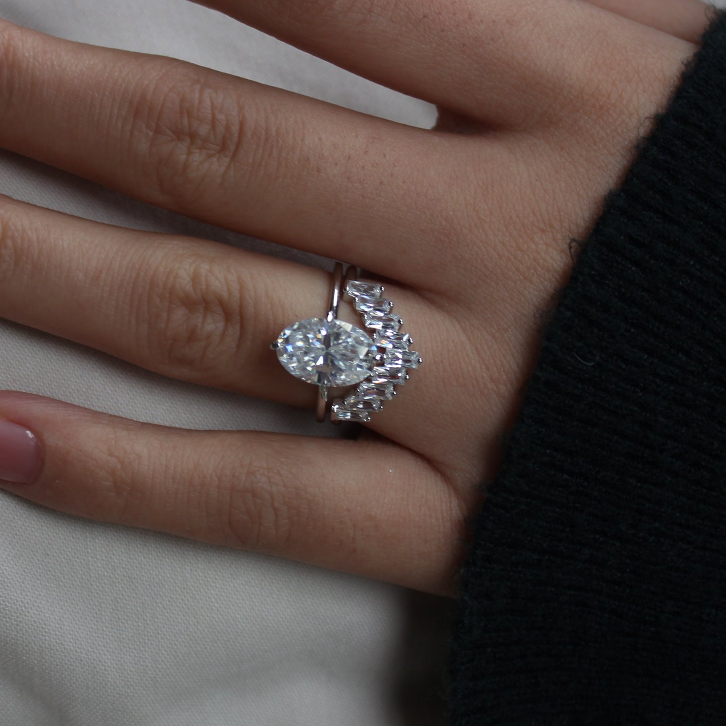 Geometric cluster moissanite ring worn on hand, angled view