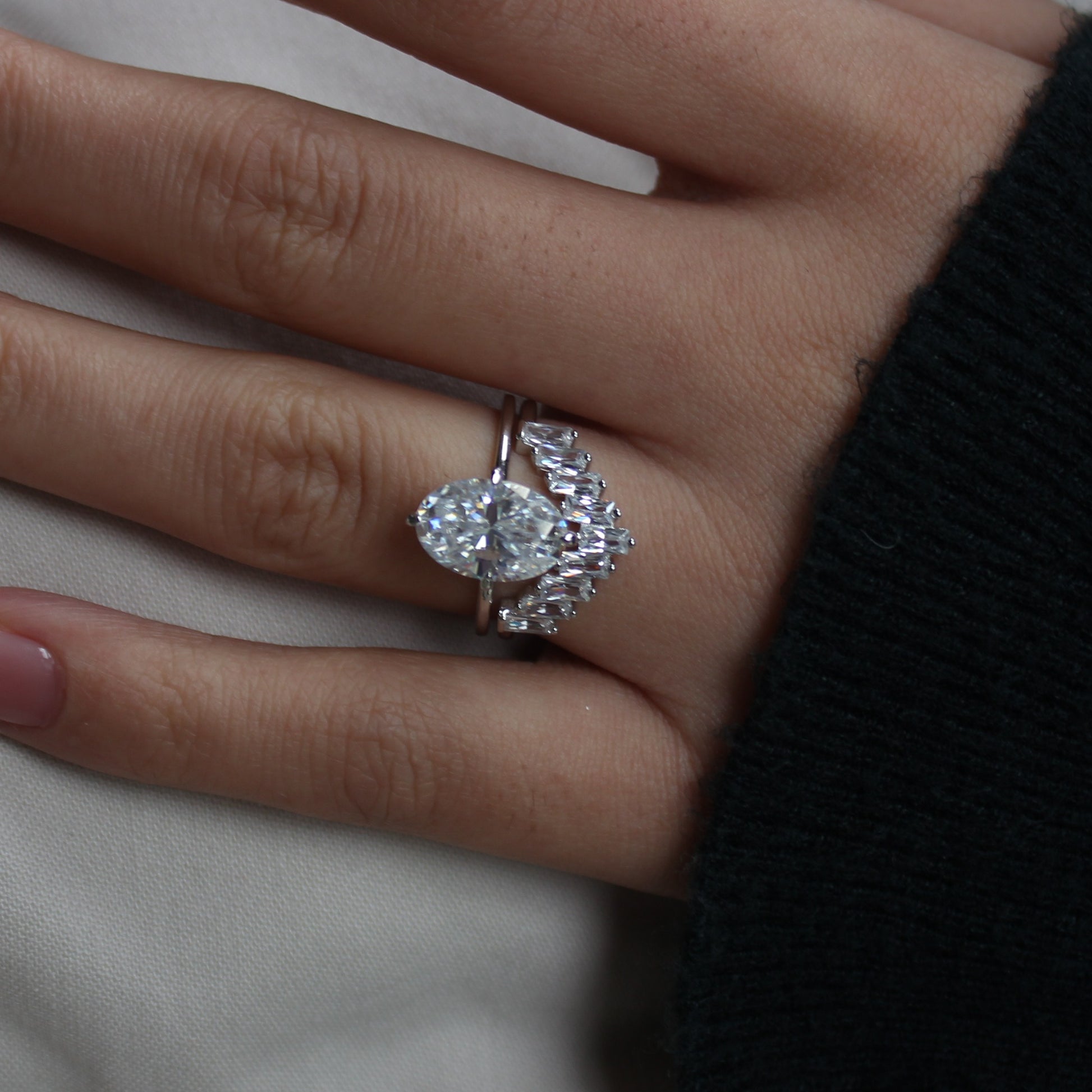 Geometric cluster moissanite ring worn on hand, angled view