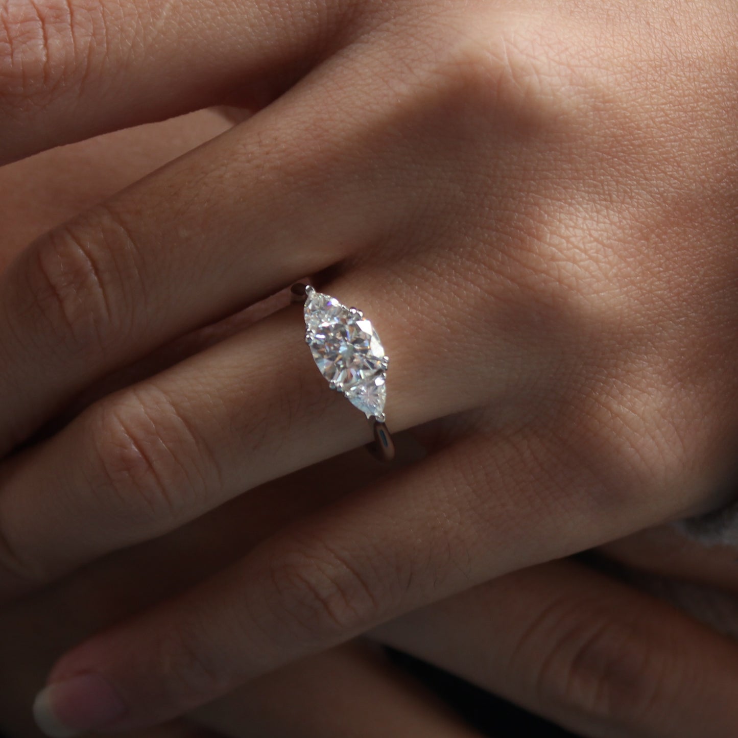 Close view of guardian cushion moissanite ring worn on finger