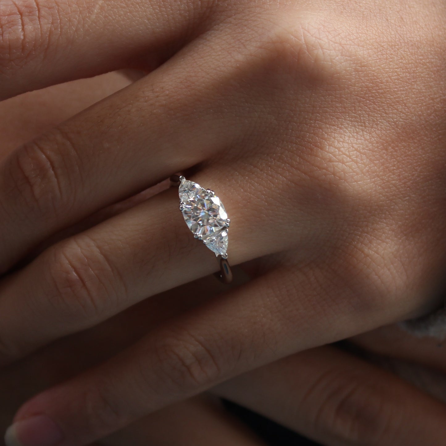 Guardian cushion moissanite ring worn on finger close up