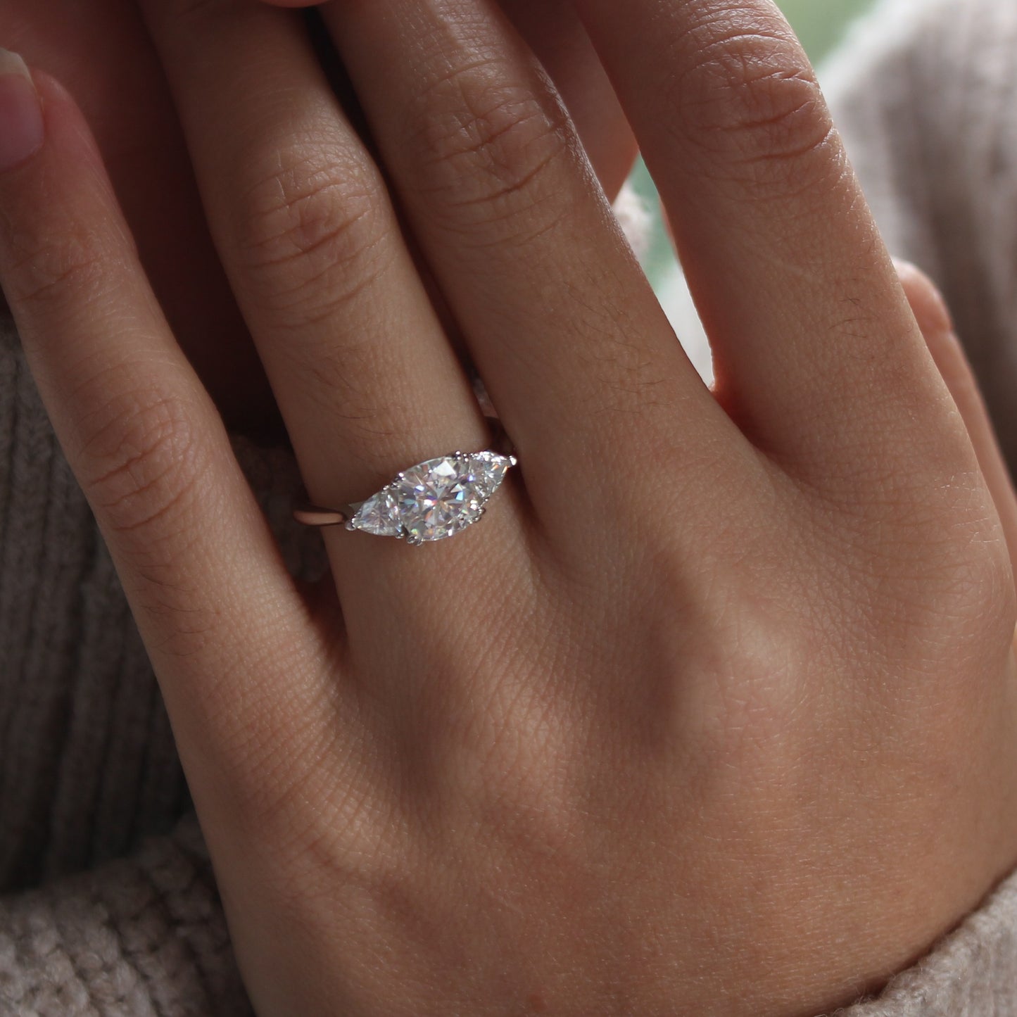 Guardian cushion moissanite ring shown on hand in natural light