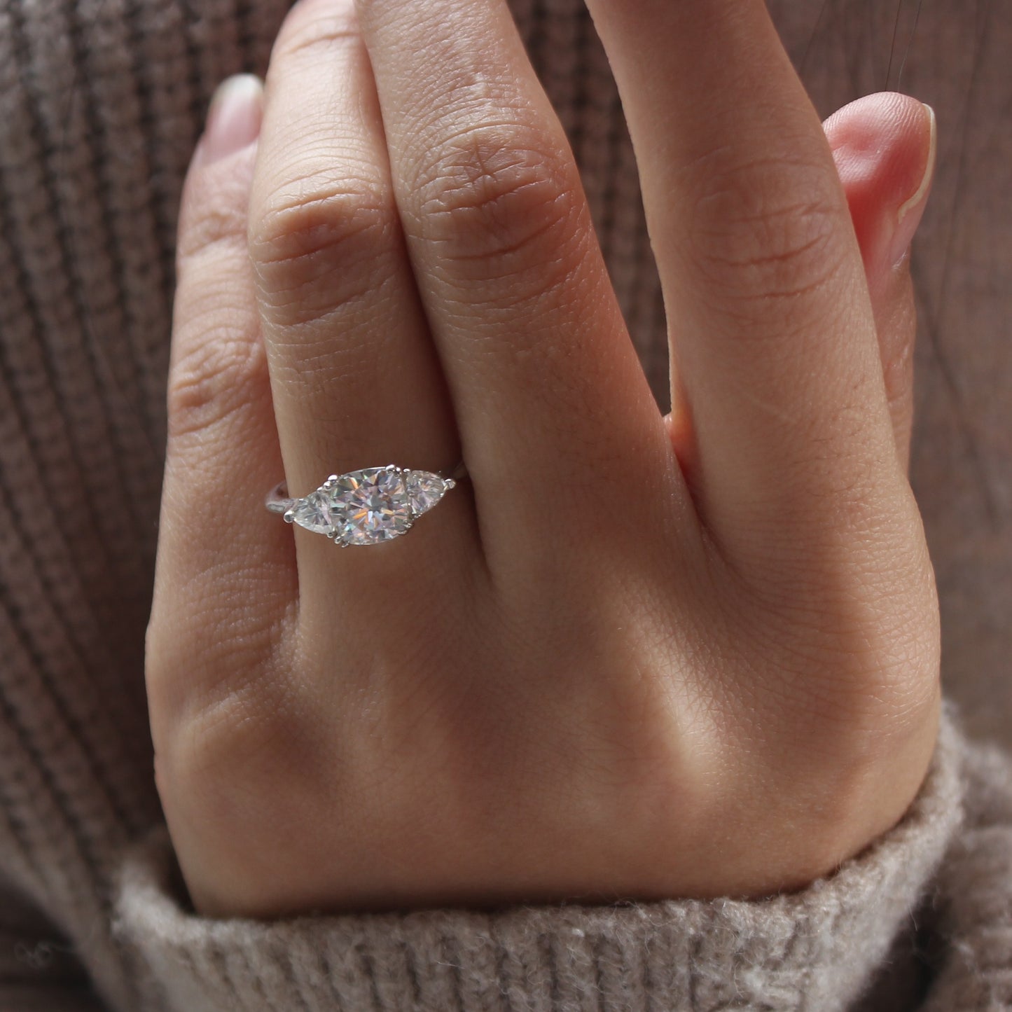 Front view of guardian cushion moissanite ring worn on finger