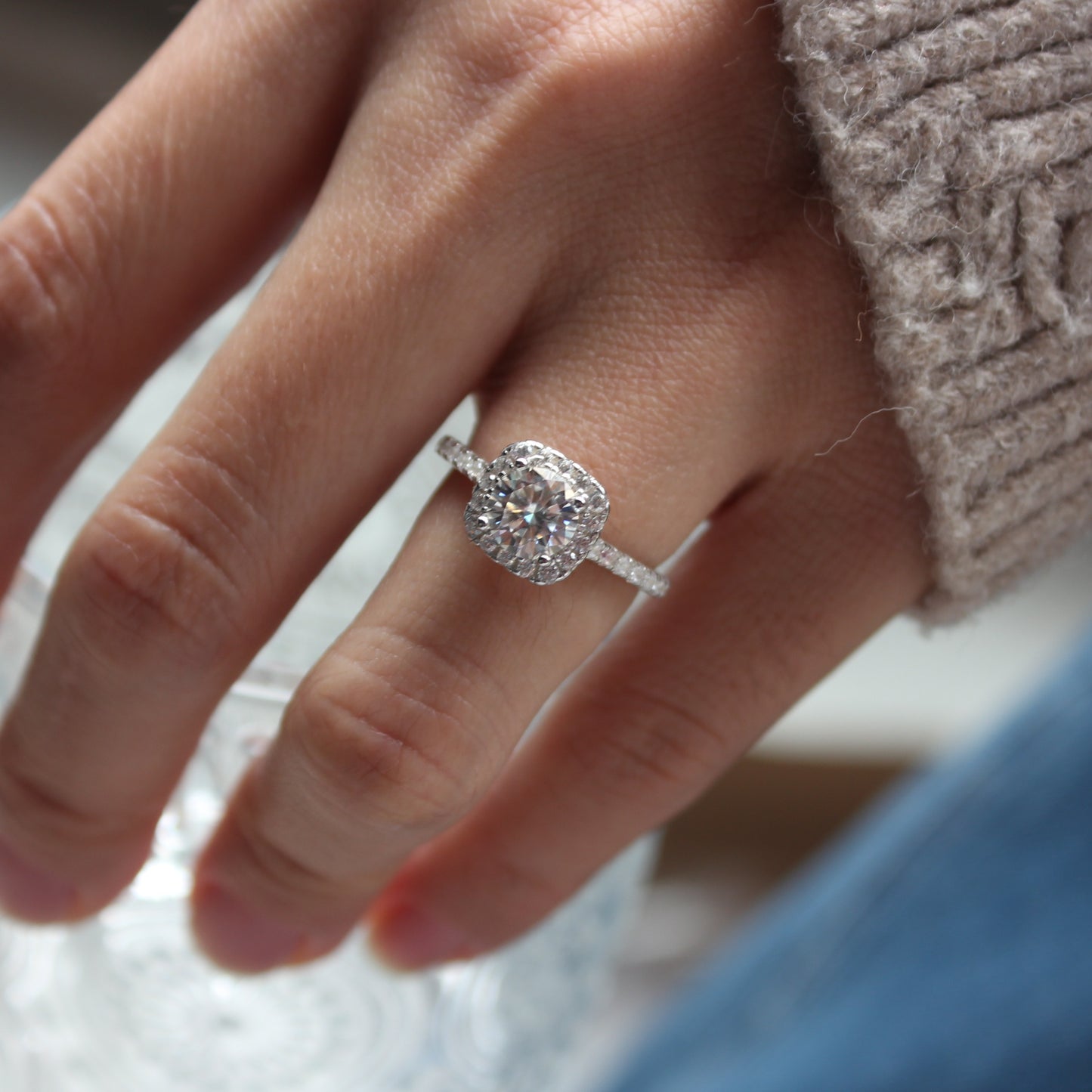Minimal halo moissanite ring worn on hand, white gold tone aesthetic
