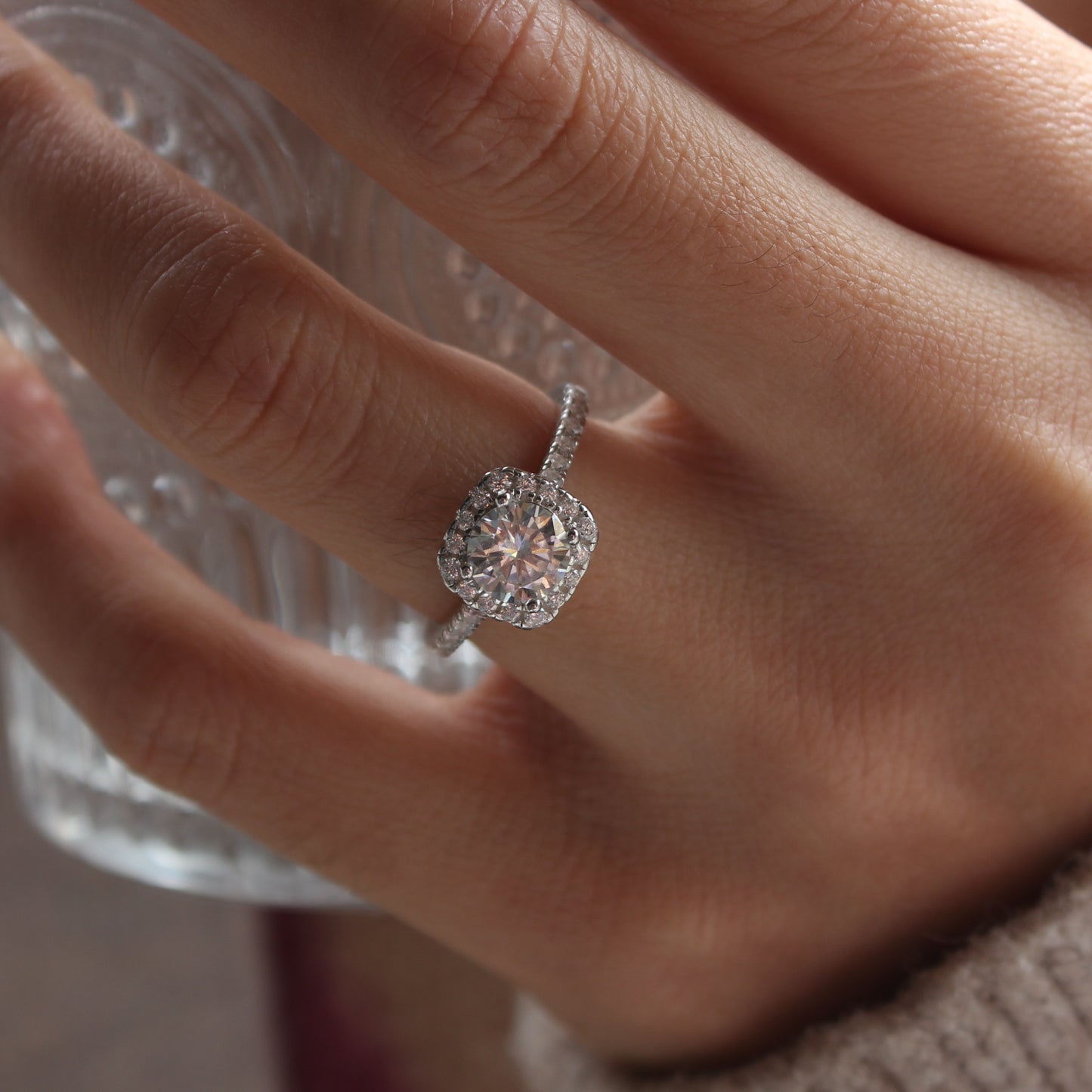 Halo pavé moissanite ring styled on hand, white gold tone stacking look