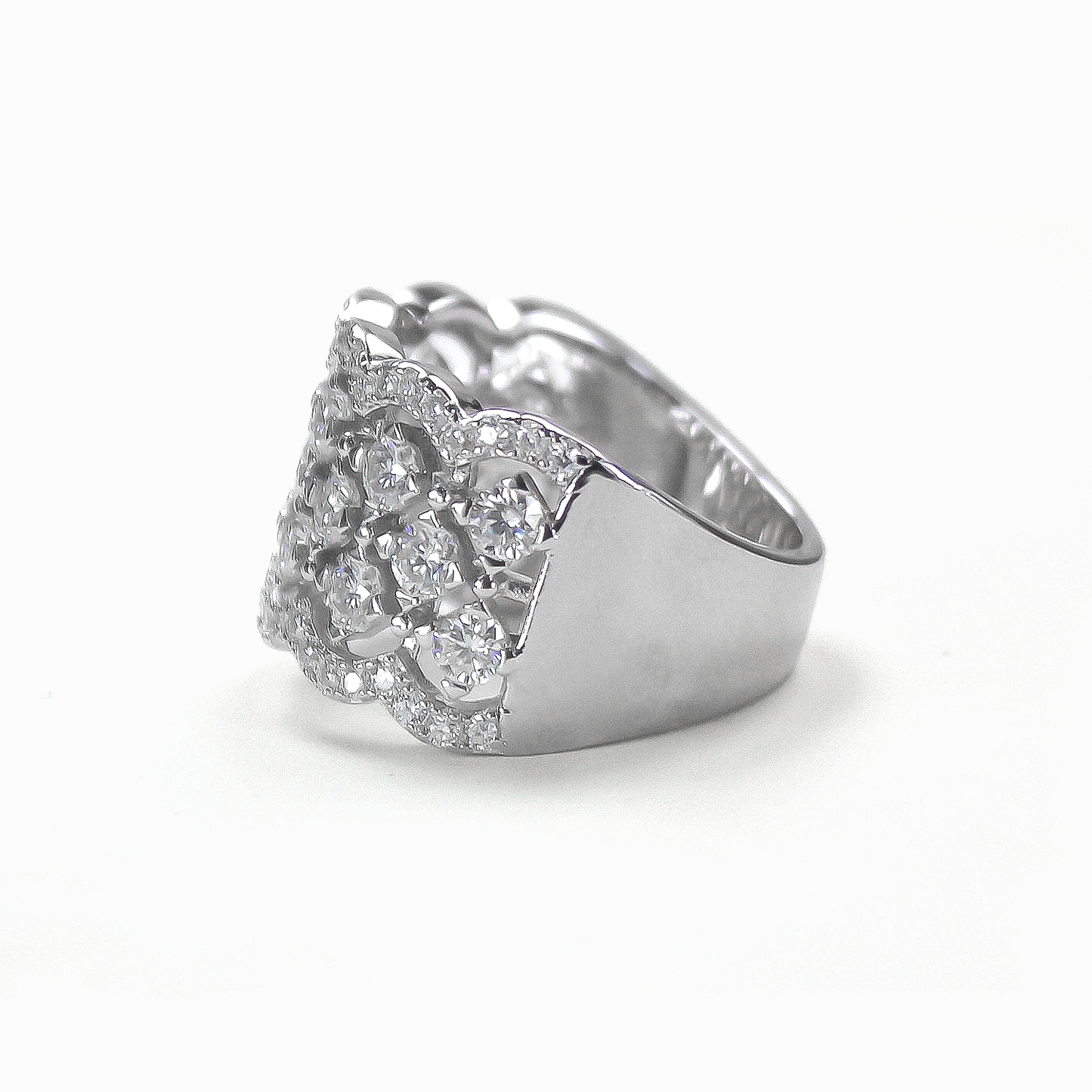Side profile of Lattice pavé moissanite statement band lying flat on white background