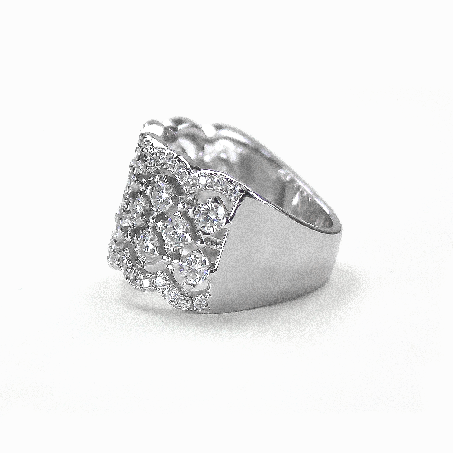 Side profile of Lattice pavé moissanite statement band lying flat on white background