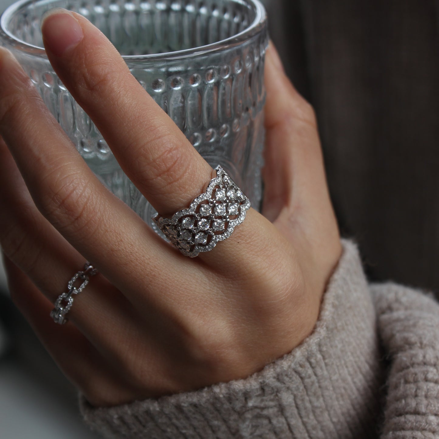 Woman wearing Lattice pavé moissanite statement band in white gold tone, bold yet refined look