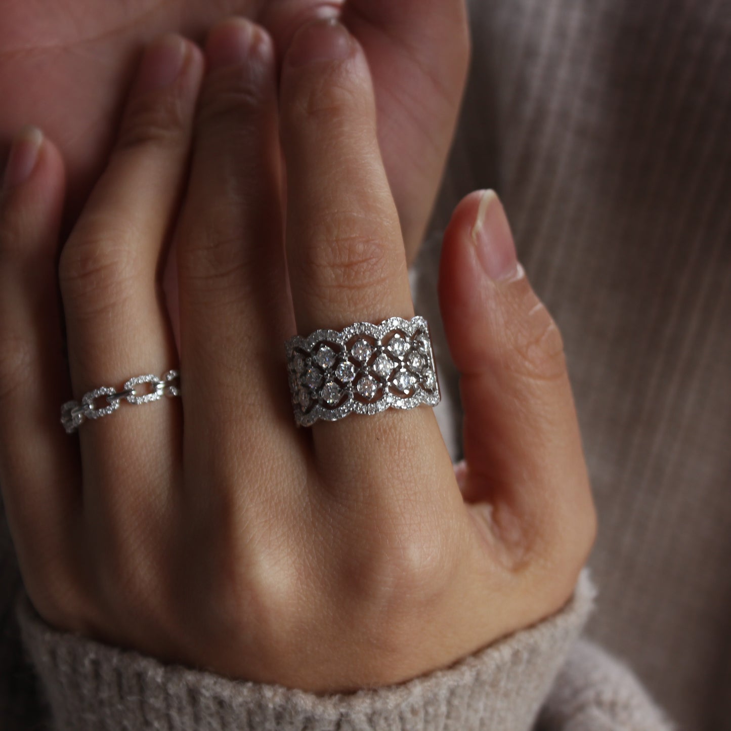 Close-up of Lattice pavé moissanite band worn on finger, intricate sparkle