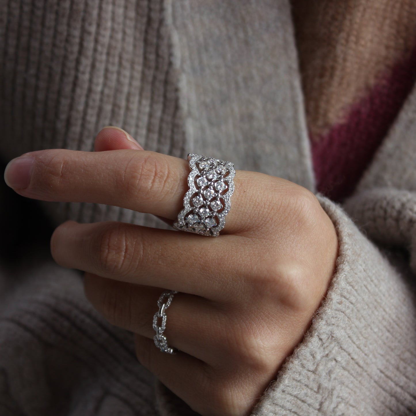 Elegant white gold tone moissanite statement band worn in natural daylight