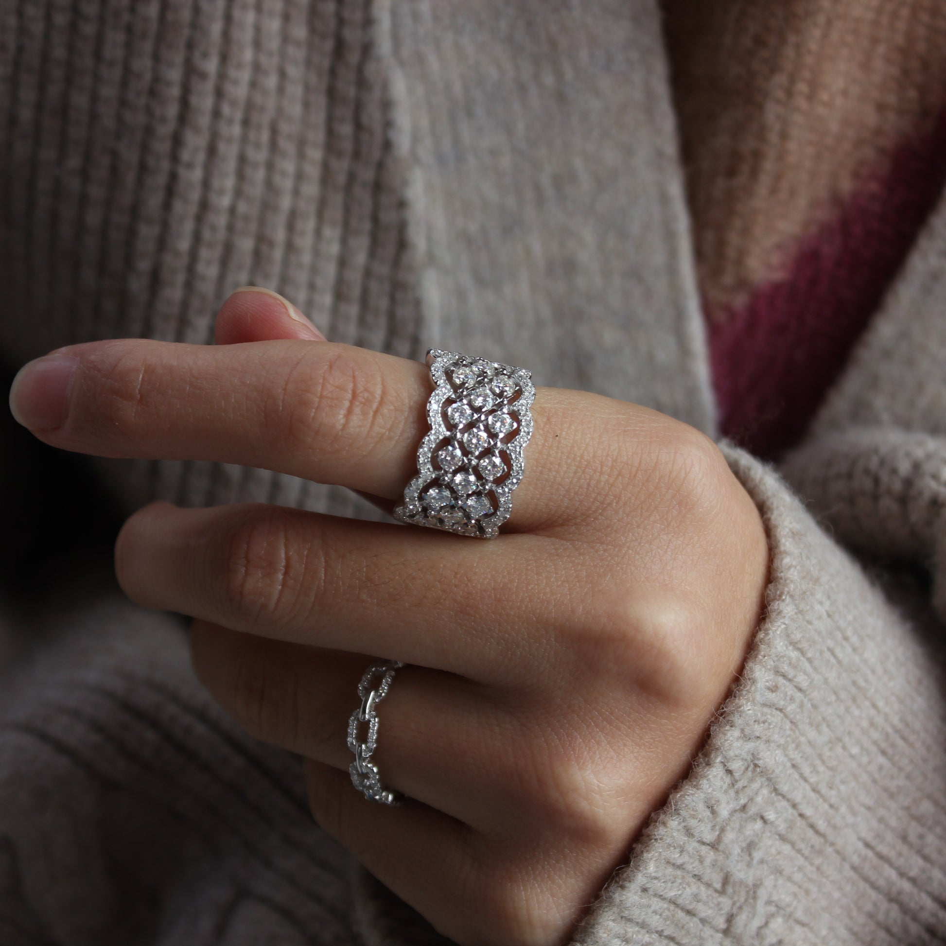 Elegant white gold tone moissanite statement band worn in natural daylight