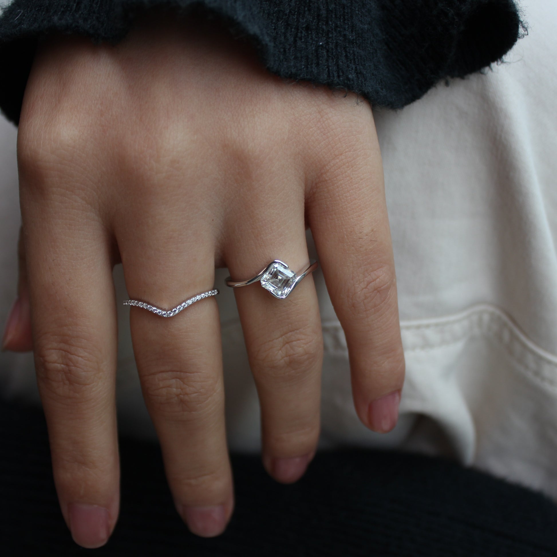 Duo moissanite ring set worn on hand, dark background
