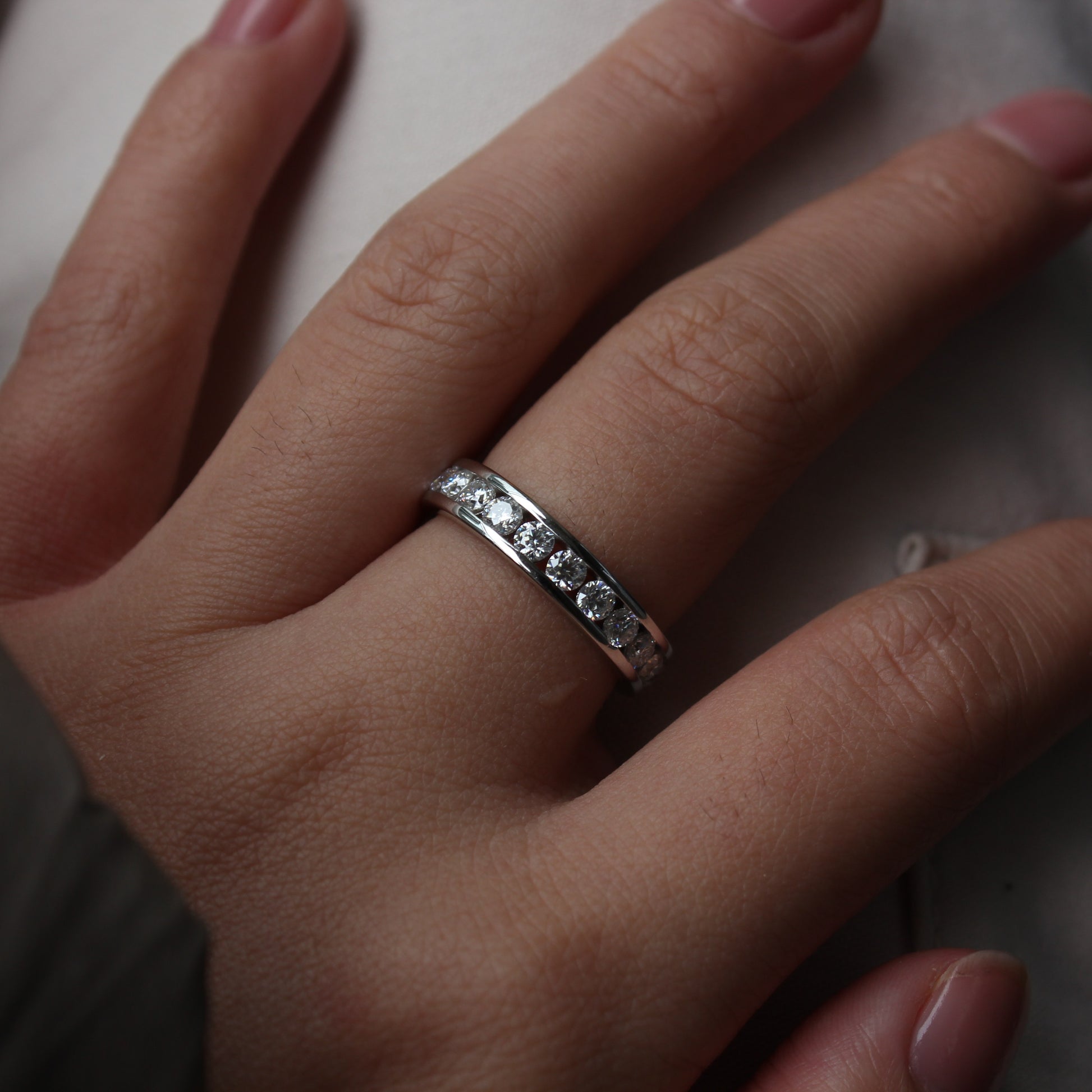 Minimalist styling of Liora moissanite band ring on hand